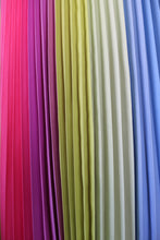 Charger l'image dans la galerie, A close up of the rainbow effect pleating in this mood boosting multicolored printed skirt. Colours designed to bring joy, this skirt is wellness fashion at its best.