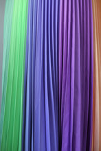 Charger l'image dans la galerie, Green, lilac, purple and orange shades blend in this close up shot of the pleats in this joyful pleated skirt, part of the Kitty Joseph Pastel Collection.