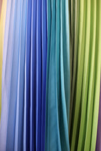 Charger l'image dans la galerie, Shades of blue pleats blending into green. This textile shot shows the crisp sunray pleats of this joyful, size-inclusive skirt design by Kitty Joseph.